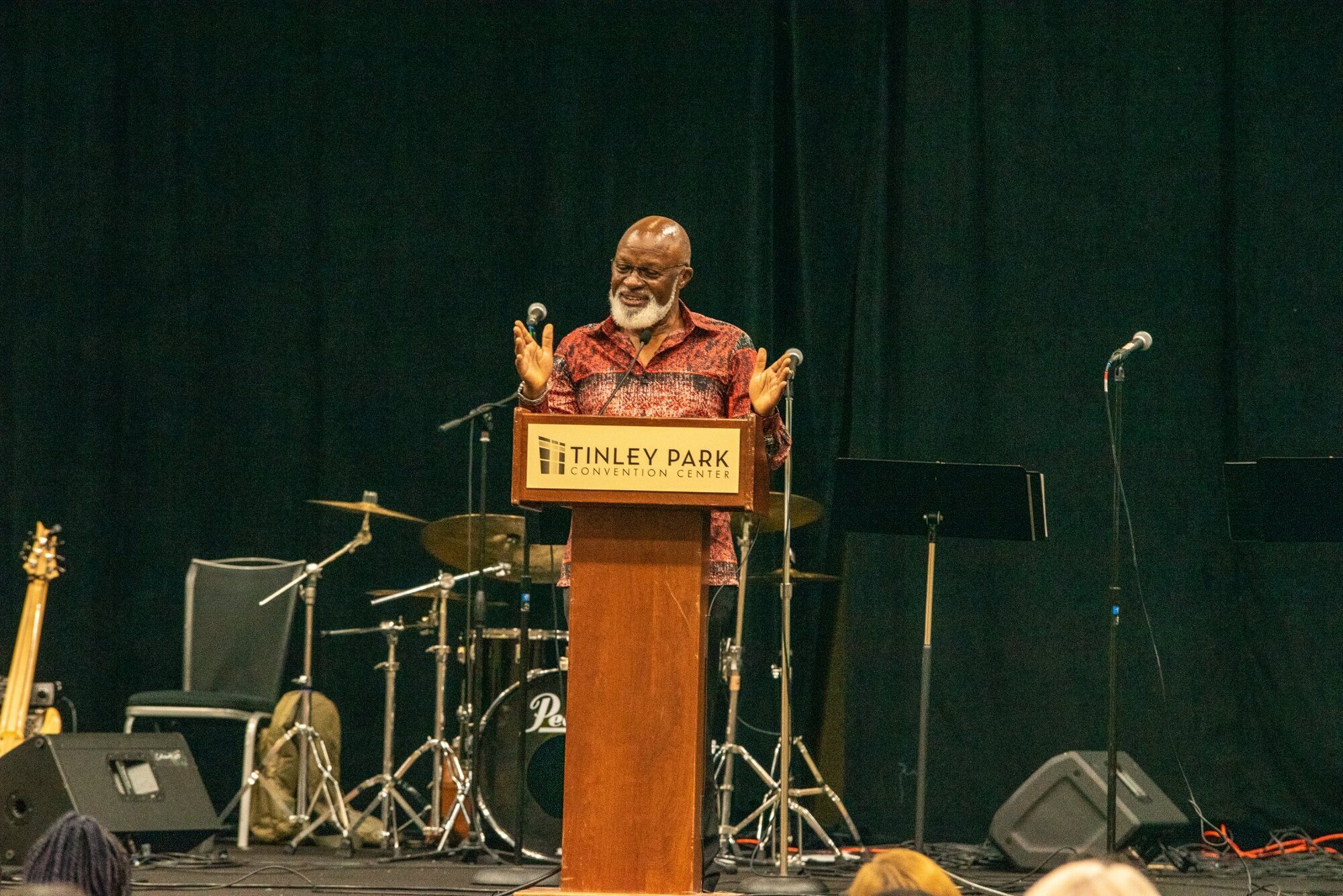 a black man speaking at a podium