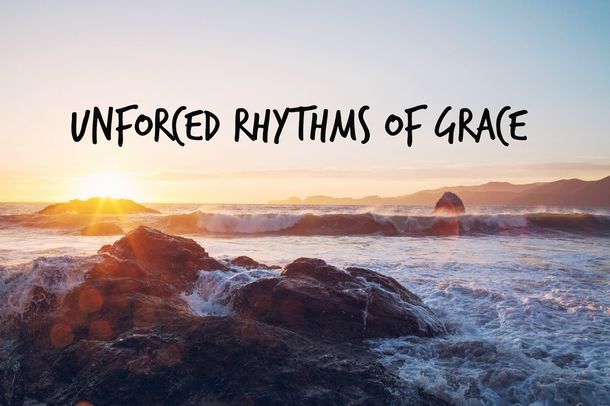 the text "Unforced Rhythms of Grace" over a sunset over the ocean